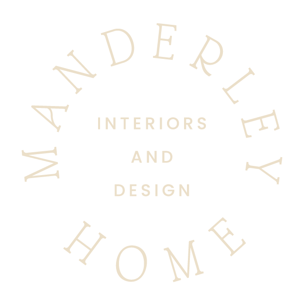 Logo with text 'MANDERLY HOME' in a circle and 'INTERIORS AND DESIGN' in the center.
