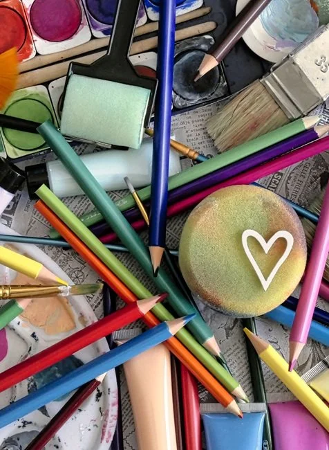 Colored pencils, paints, and paintbrushes