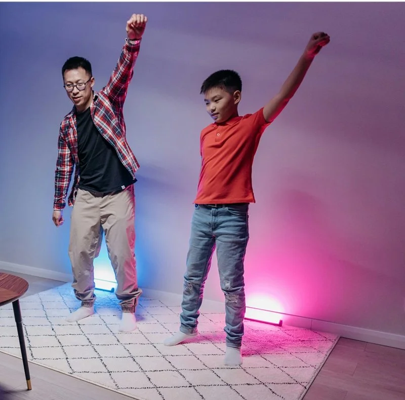 Dad and son dancing on rug