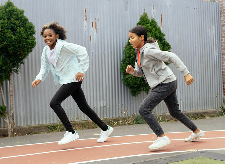 Two girls running outside