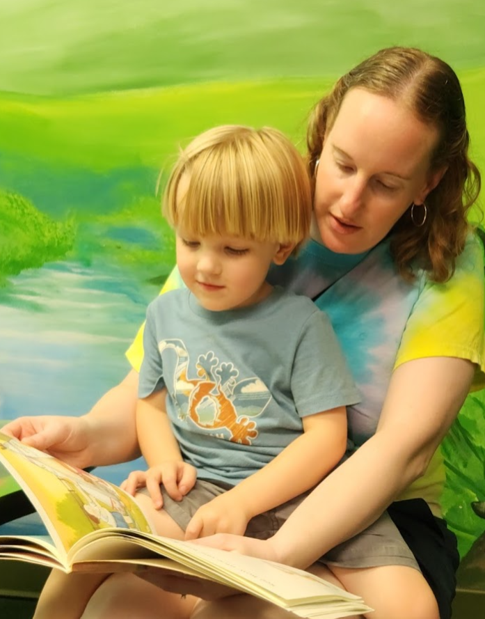 Robyn reading with her son.