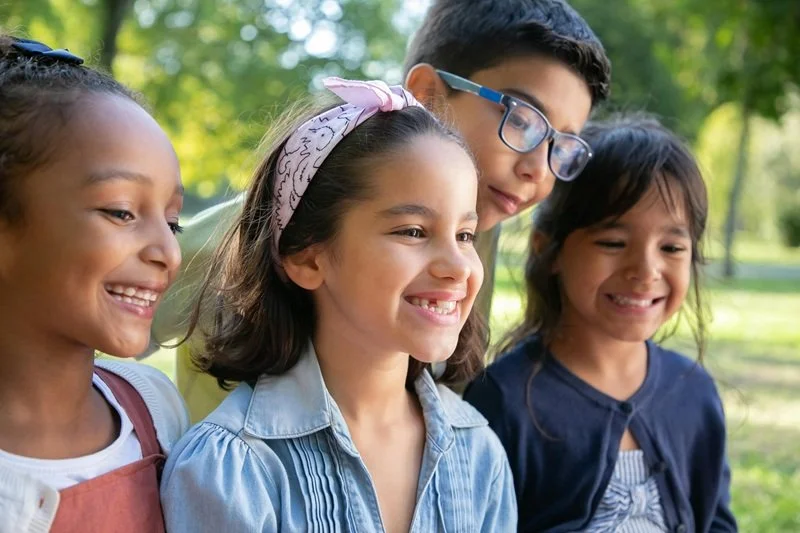 4 kids smiling outside