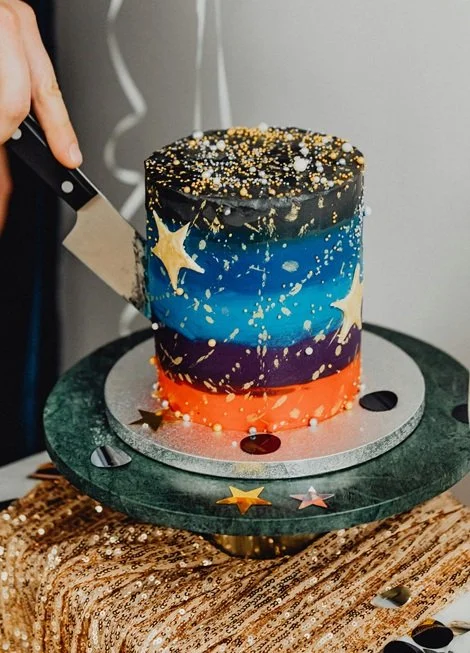 Person cutting into space cake.