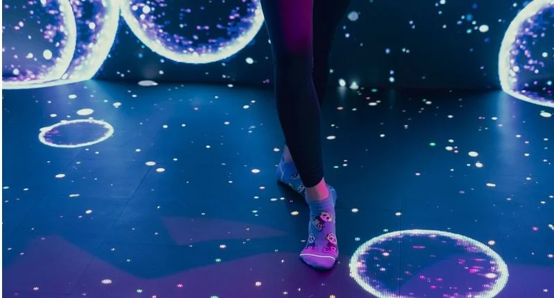 Woman's feet on an interactive floor.