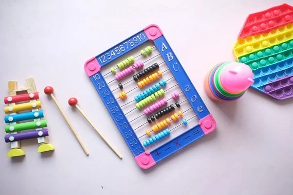 Abacus, popper, xylophone, and other toys