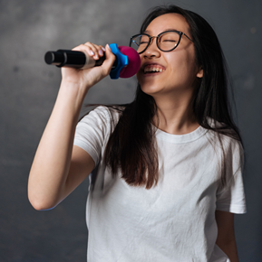 Young lady singing into microphone