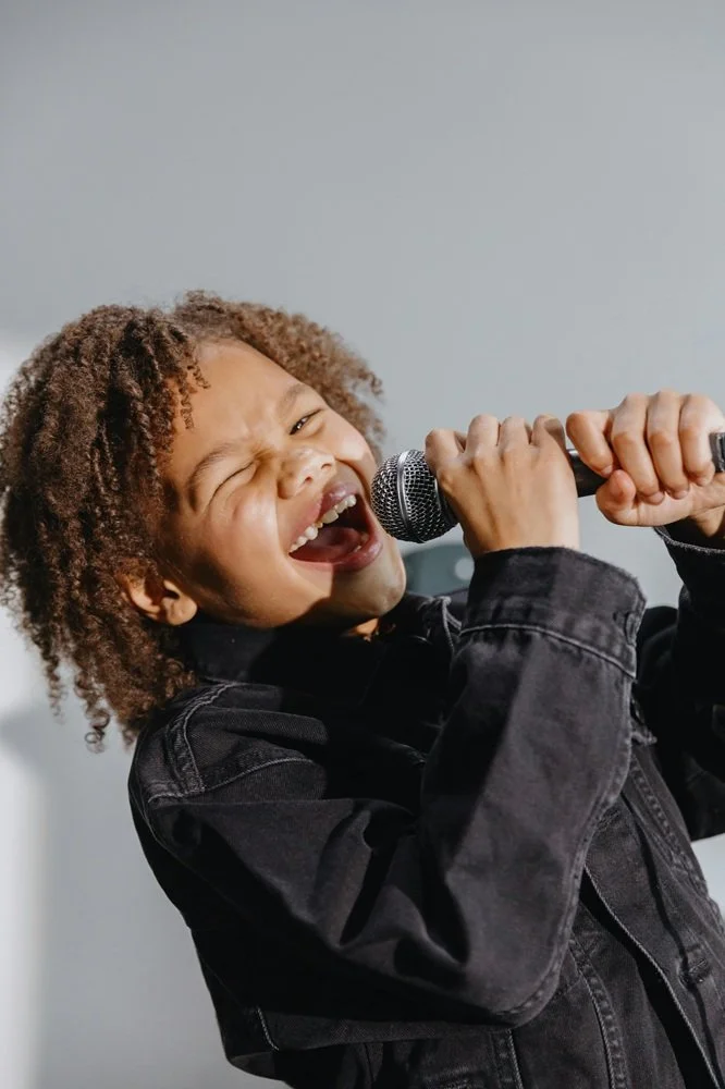 Kid singing into microphone