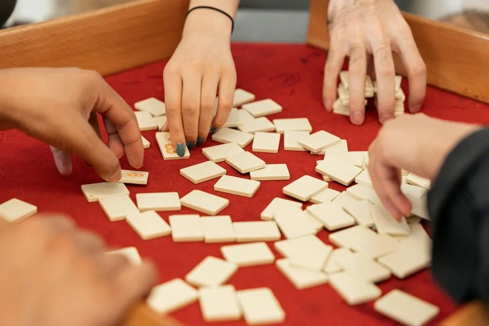 Hands picking up tiles