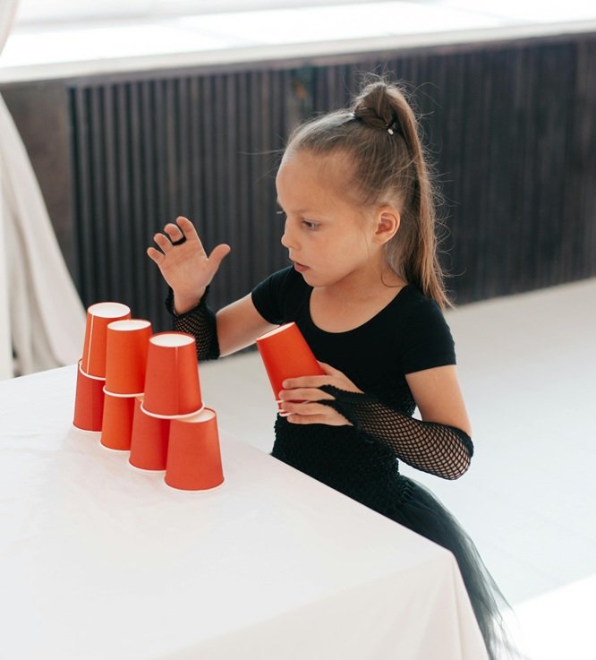 Girl doing Minute to Win It game