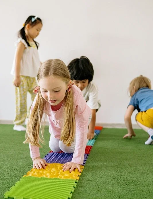 Kids crawling on sensory squares
