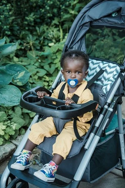 Baby with pacifier sitting in stroller