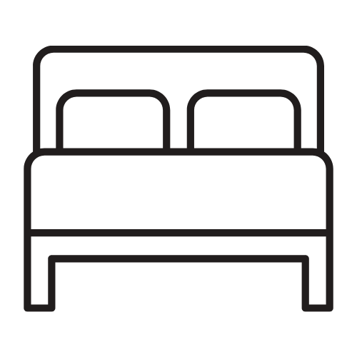 Cama doble con dos almohadas en una habitación