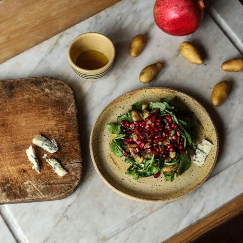 Wild Arugula, Potato, and Pomegranate Salad with a Lemon Blossom Honey Vinaigrette and Blue Cheese