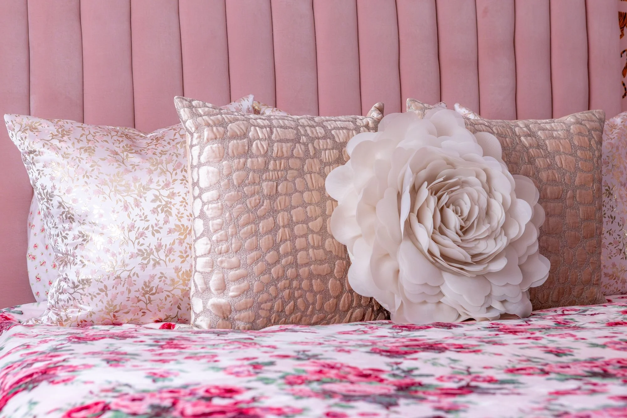 pink pillow vignette in an all pink bedroom designed for adults