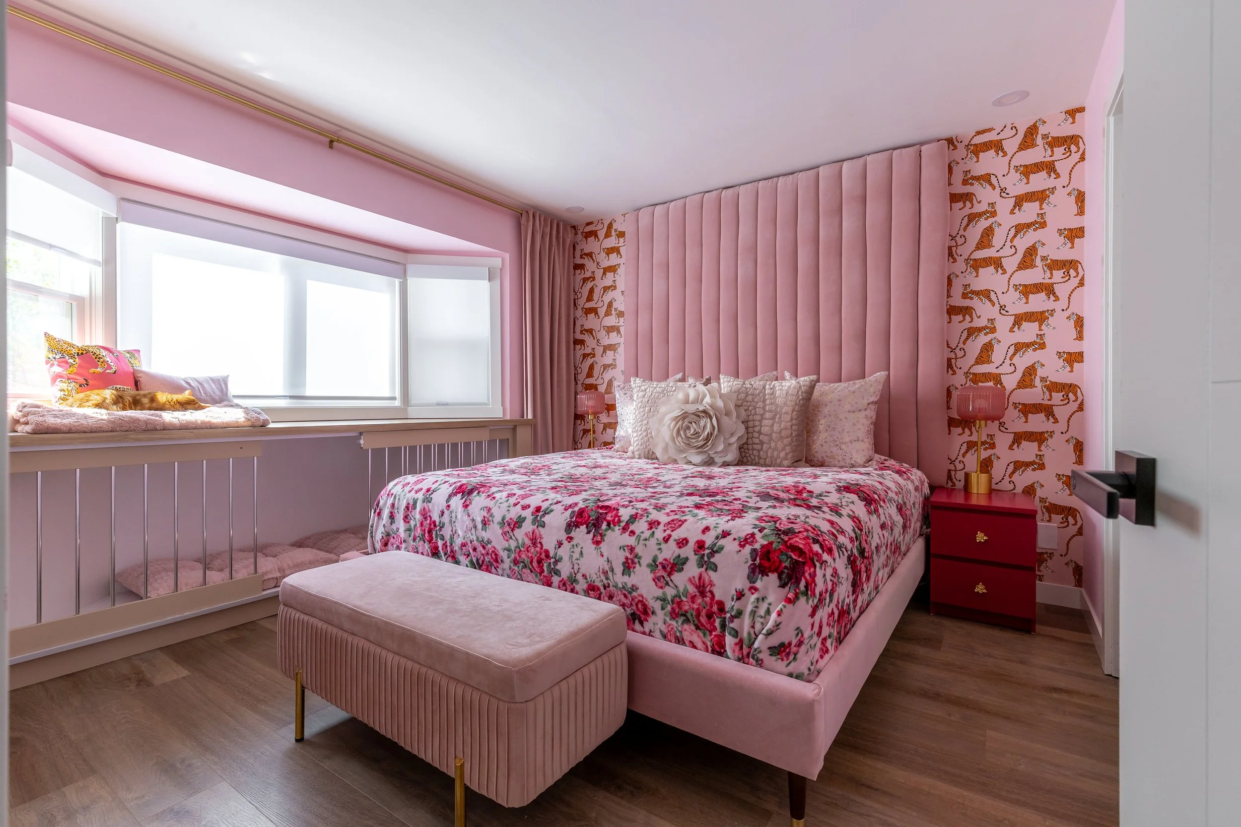 all pink bedroom is shown decorated for adults with bold design and maximalist preferences