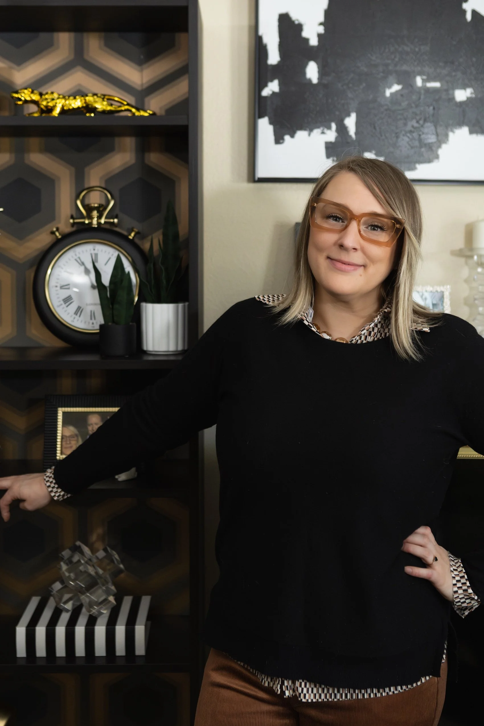 an interior design consultant from Las Vegas stands confidently in front of a living room design project she completed
