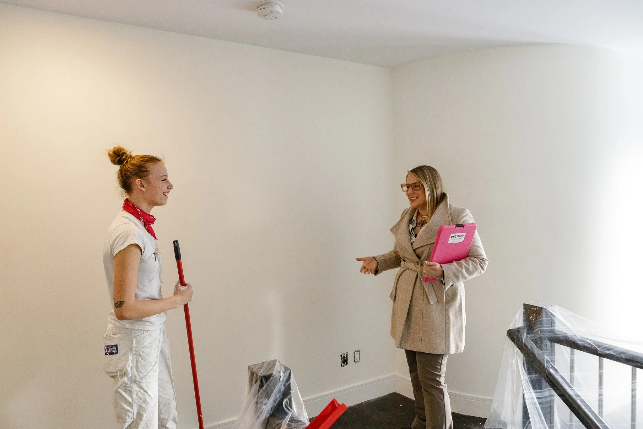 a girl is shown directing another girl on her painting and color consultation skills