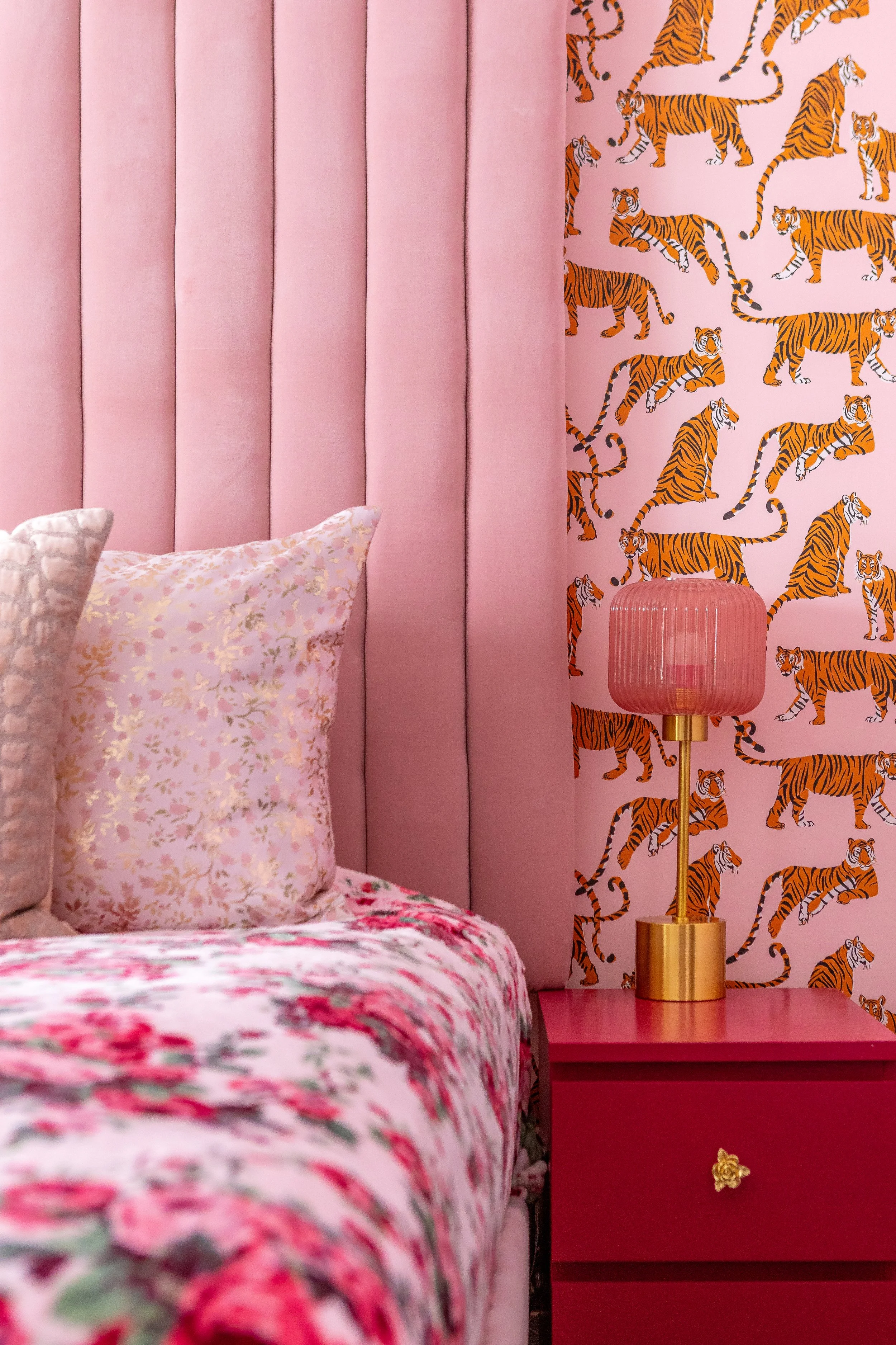 a picture of an all pink bedroom is shown.  the photo shows the details in what makes this pink maximalist bedroom designed for adults
