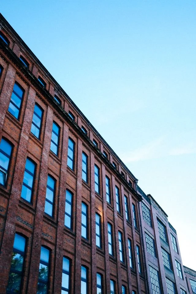 A large block of flats, converted from a red brick Victorian warehouse.