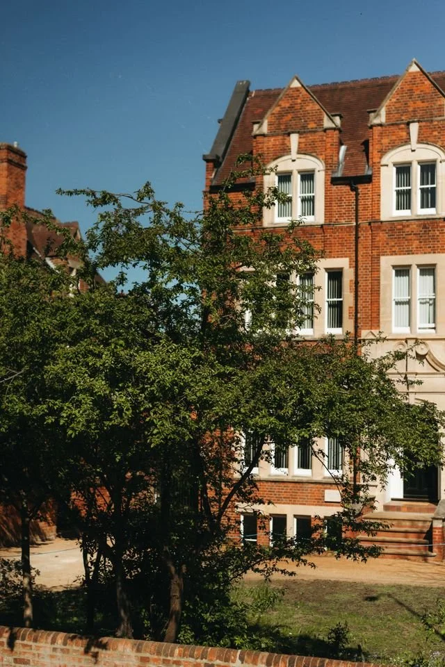 Red brick terraced houses on a green in Kensington, London.
