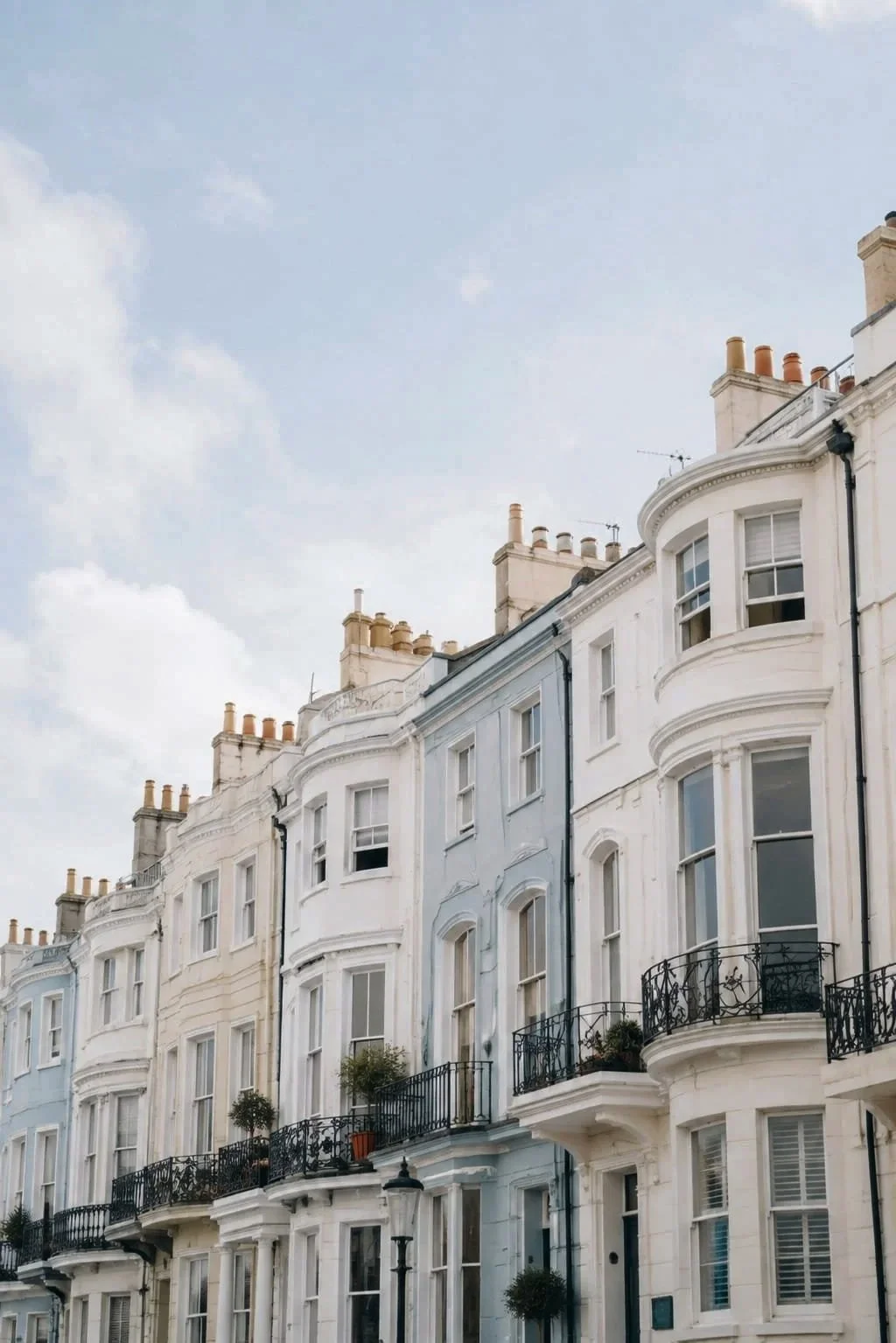 A row of pale coloured terraced town houses for rental in Brighton.