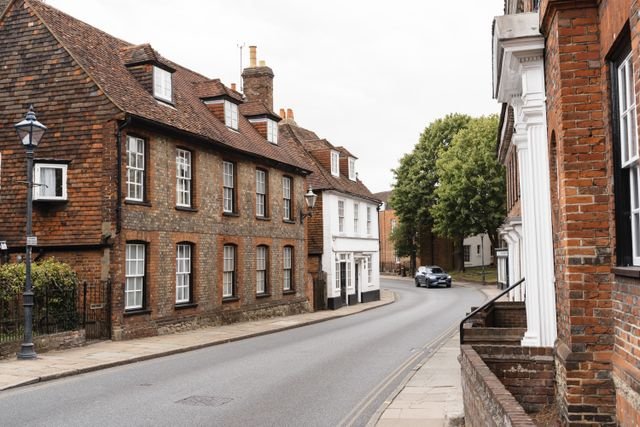 A quiet street lined with old brick terraced houses.