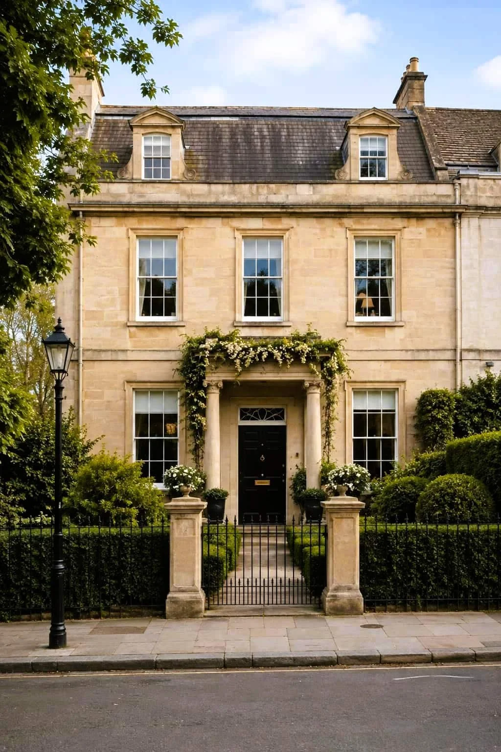 Large Georgian terraced house with hedgerows in an affluent residential street in London.