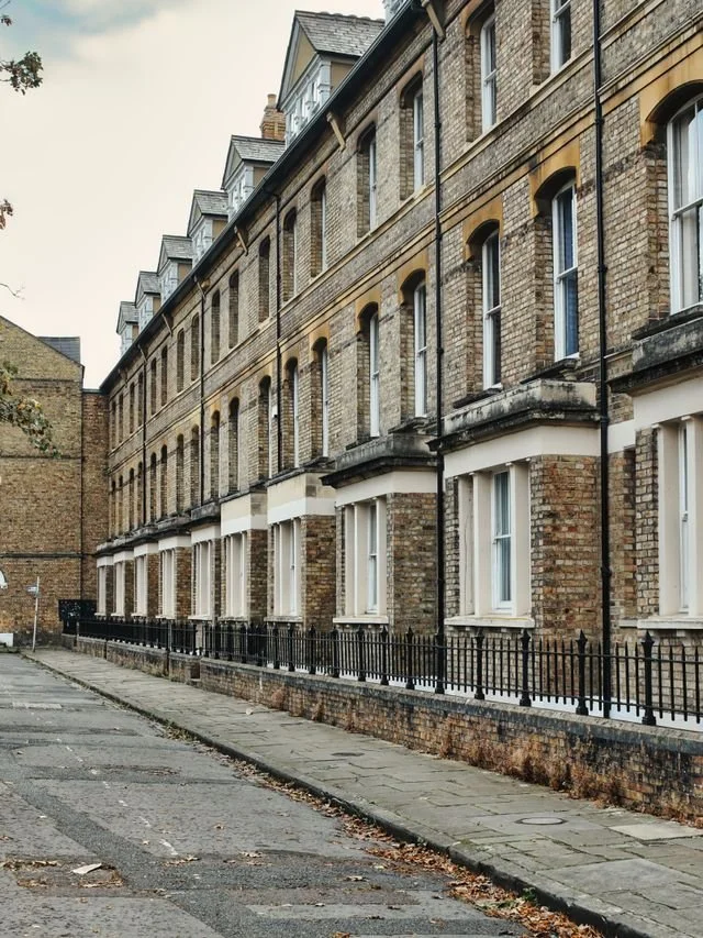 A row of pale brick London town houses in a former industrial area.
