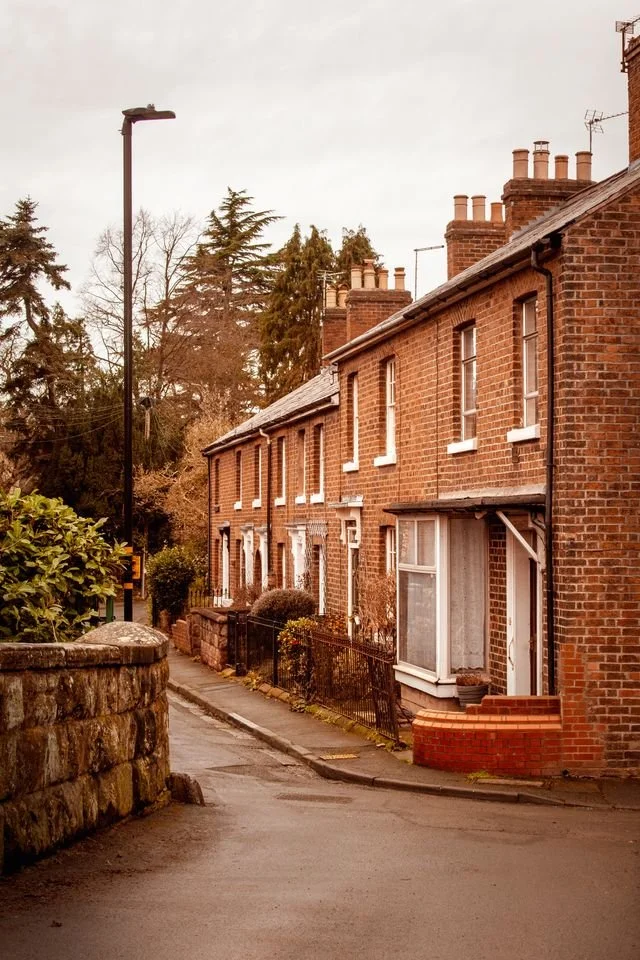 A row of red brick Victorian terrace houses.