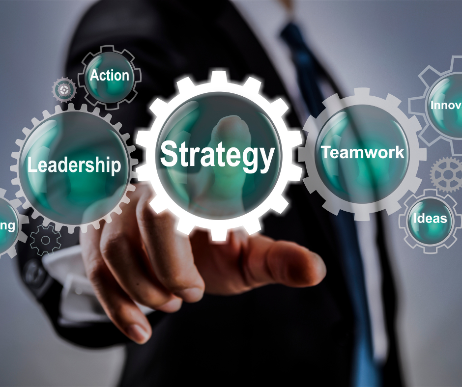 A person in a suit interacts with a digital interface featuring gears and keywords such as"Strategy,""Leadership,""Action,""Teamwork,""Innovate," and"Ideas."
