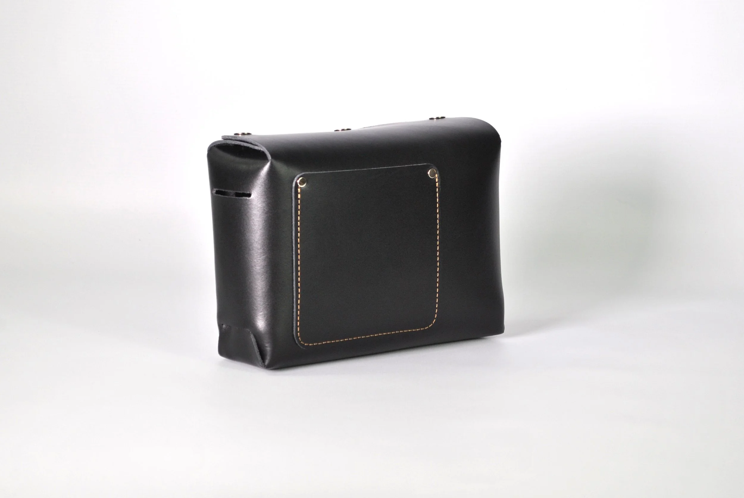 Black leather briefcase with a rectangular front pocket and yellow stitching, set against a plain white background.