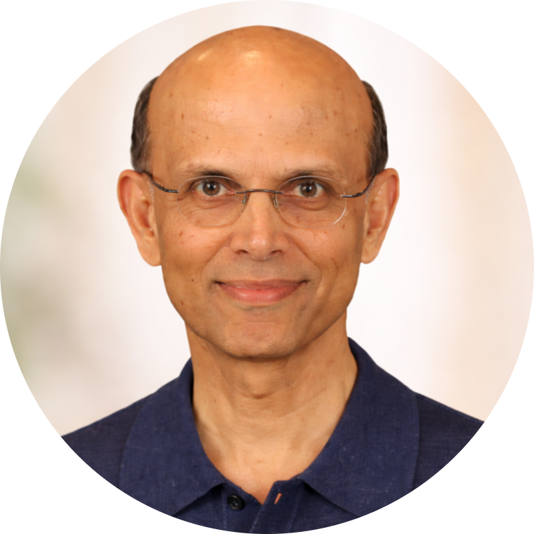 Professional headshot of Ranga Jayaraman wearing glasses and a navy collared shirt, facing forward against a soft neutral background.