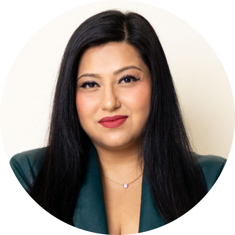 Headshot of Khushboo Chabria wearing a dark green blazer, with long straight black hair and a neutral background.
