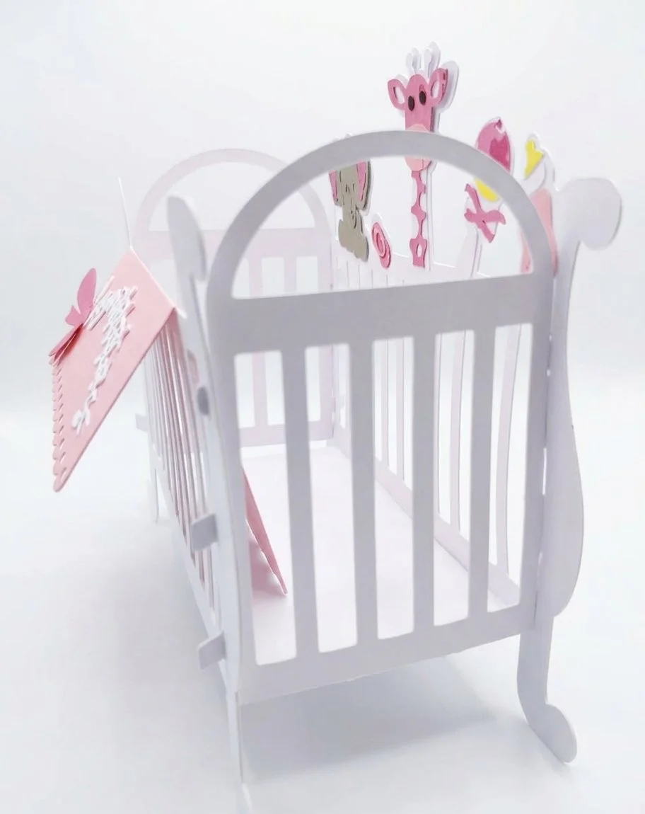 Precision-cut design replicates a classic cot including slatted sides and curved headboard.