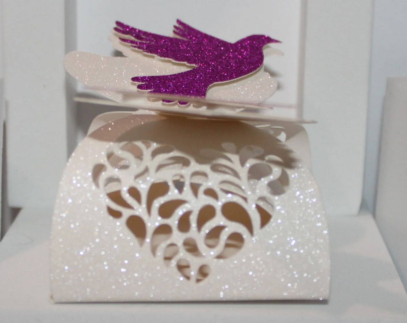 Dove Favour Box!
This gorgeous box has been cut with two doves holding a heart. .
The doves close the box making this a stunning piece. #0062




