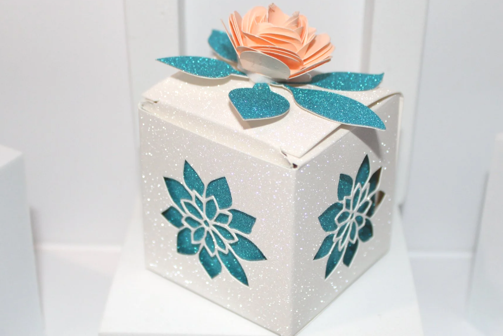 Rose favour box!
Okay, have you seen this adorable wedding favor box with a rose on the lid? 

It’s a total game changer for your big day!

Picture this: a cute little box crafted from shimmering white glitter card, and those intricate flower cutouts
