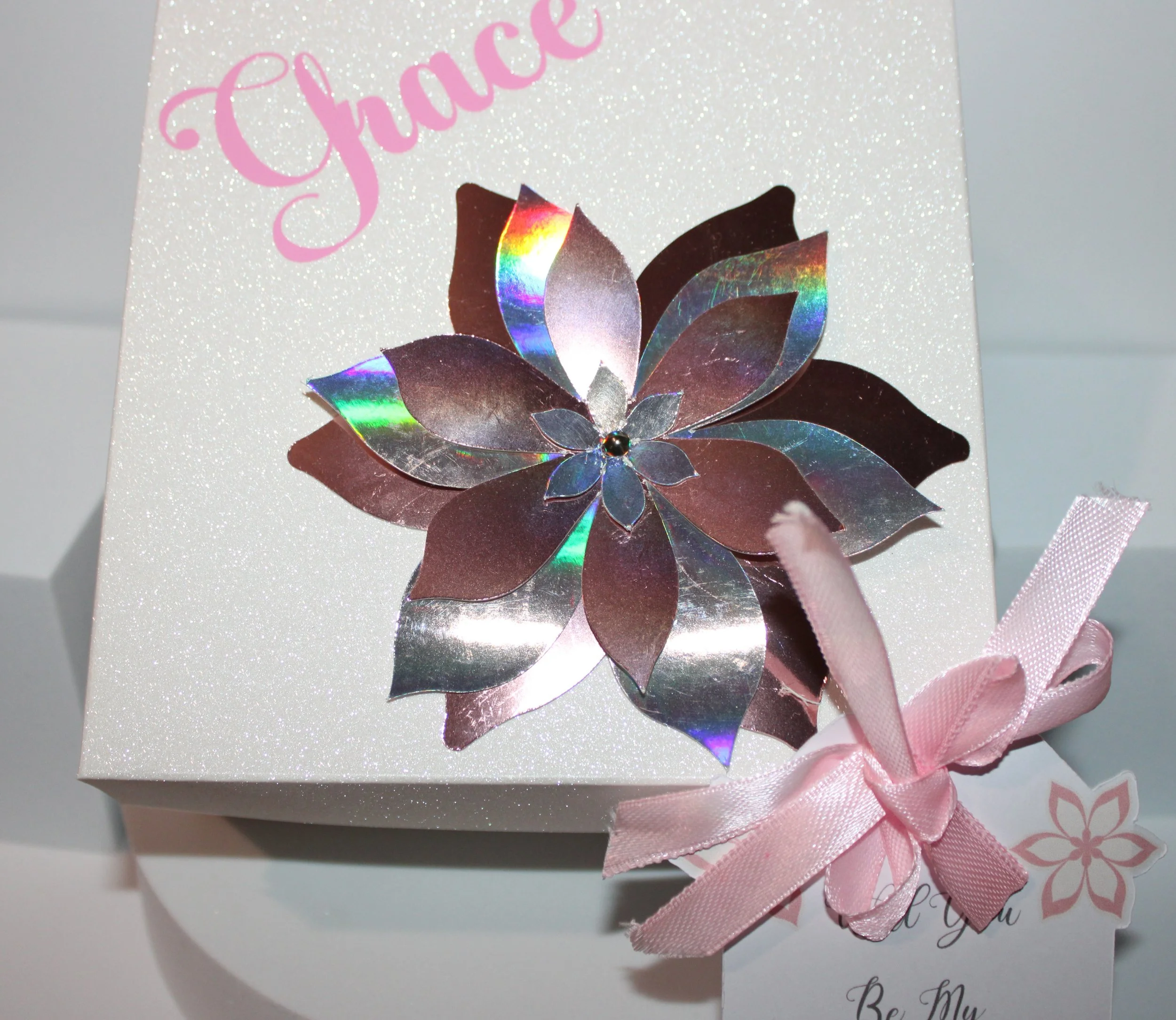 The perfect gift box!

Ask your best friend/family member to be your bridesmaid or maid of honour with the cutest gift box. 
The boxes have their names attached to the lid in a lovely pink vinyl. In addition there is also a flower that is cut out of 