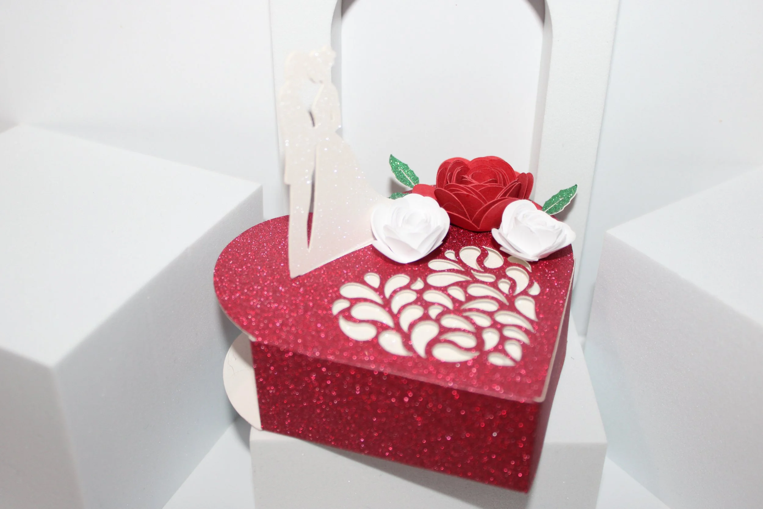 There is also an intricate heart cut into the box that adds that extra special touch. Plus there are 3 red & white roses just for that perfect finish.