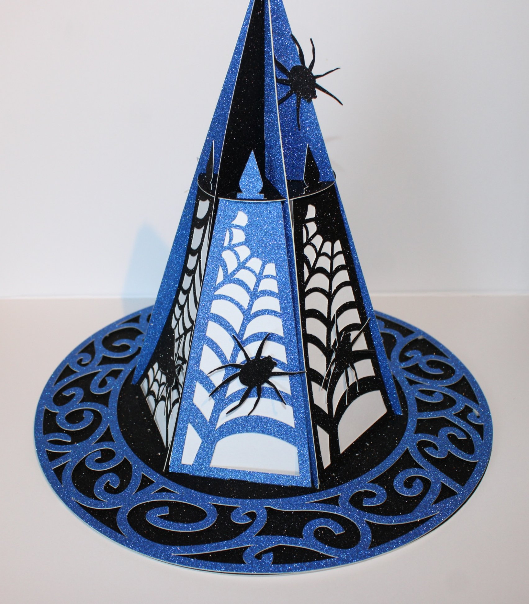 Halloween Hat Lantern With LED Lights Inside!
A bewitching centrepiece for Halloween or themed décor, this witches’ hat lantern is cut entirely from sturdy card and finished with haunted detailing for a spookily elegant look.
Designed to hold shape a