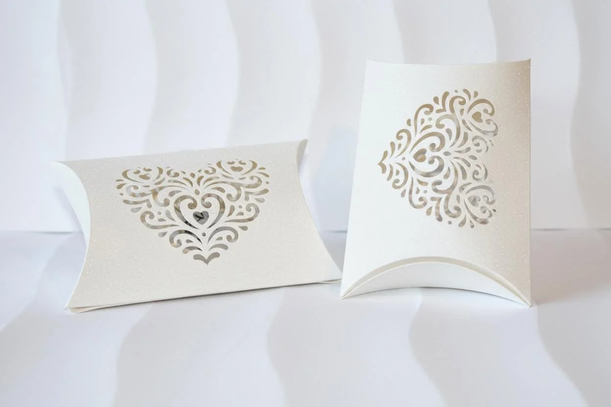 Pillow favour box!
This adorable little box is cut in the shape of a pillow, and it features beautifully intricate hearts on either side. #0084

