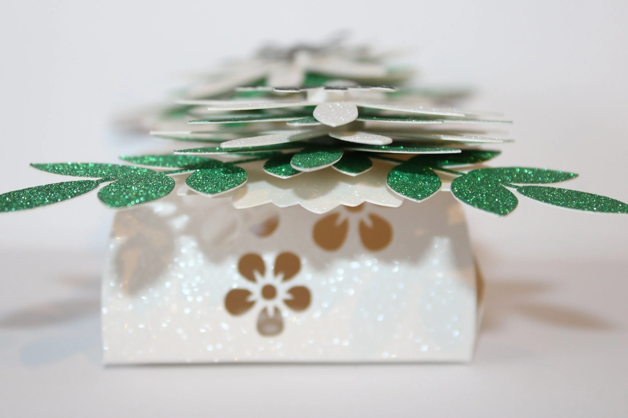 Little flowers have been delicately cut onto the sides of the box.