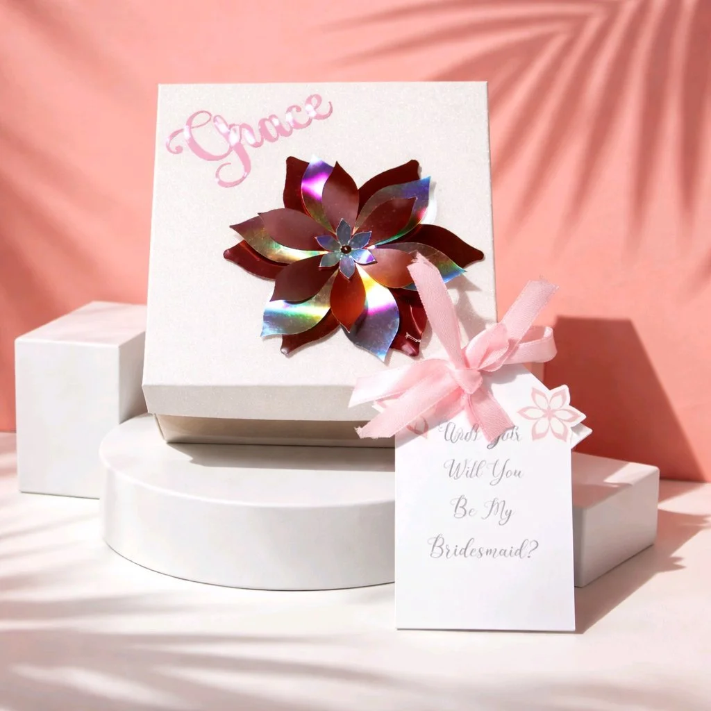The perfect gift box!

Ask your best friend/family member to be your bridesmaid or maid of honour with the cutest gift box. 
The boxes have their names attached to the lid in a lovely pink vinyl. In addition there is also a flower that is cut out of 