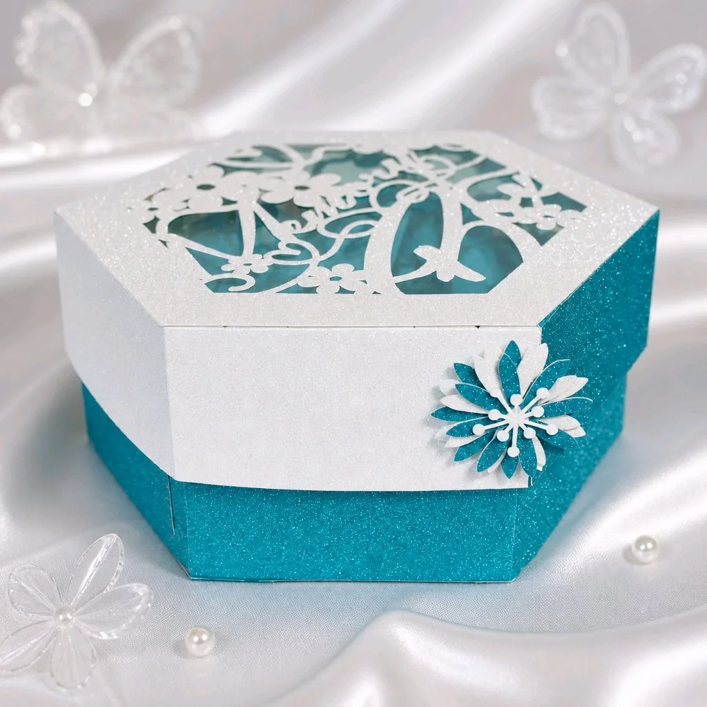 Celebrate a beloved companion with a beautifully crafted hexagon pet memory box.
Made from high-quality glitter card. The acetate window ensures treasured items inside are visible while kept safe. Hexagon shape for a unique, modern look. The Inside i
