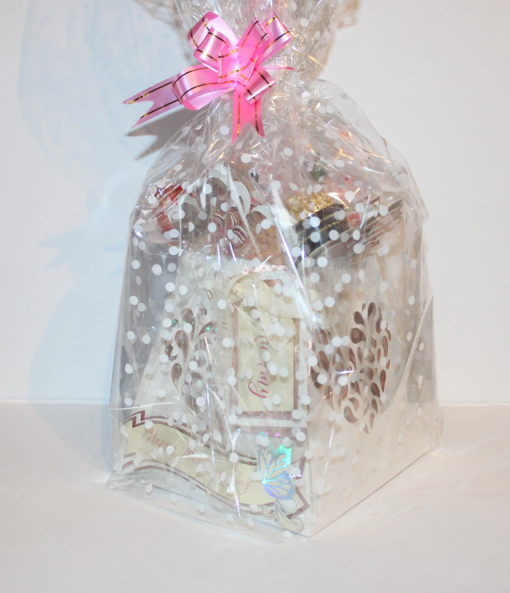 Carefully packaged in clear cellophane and wrapped with a pink bow. Customisation options available: Choice of sweets, name/text for the prop stick, and alternative banner wording on request.