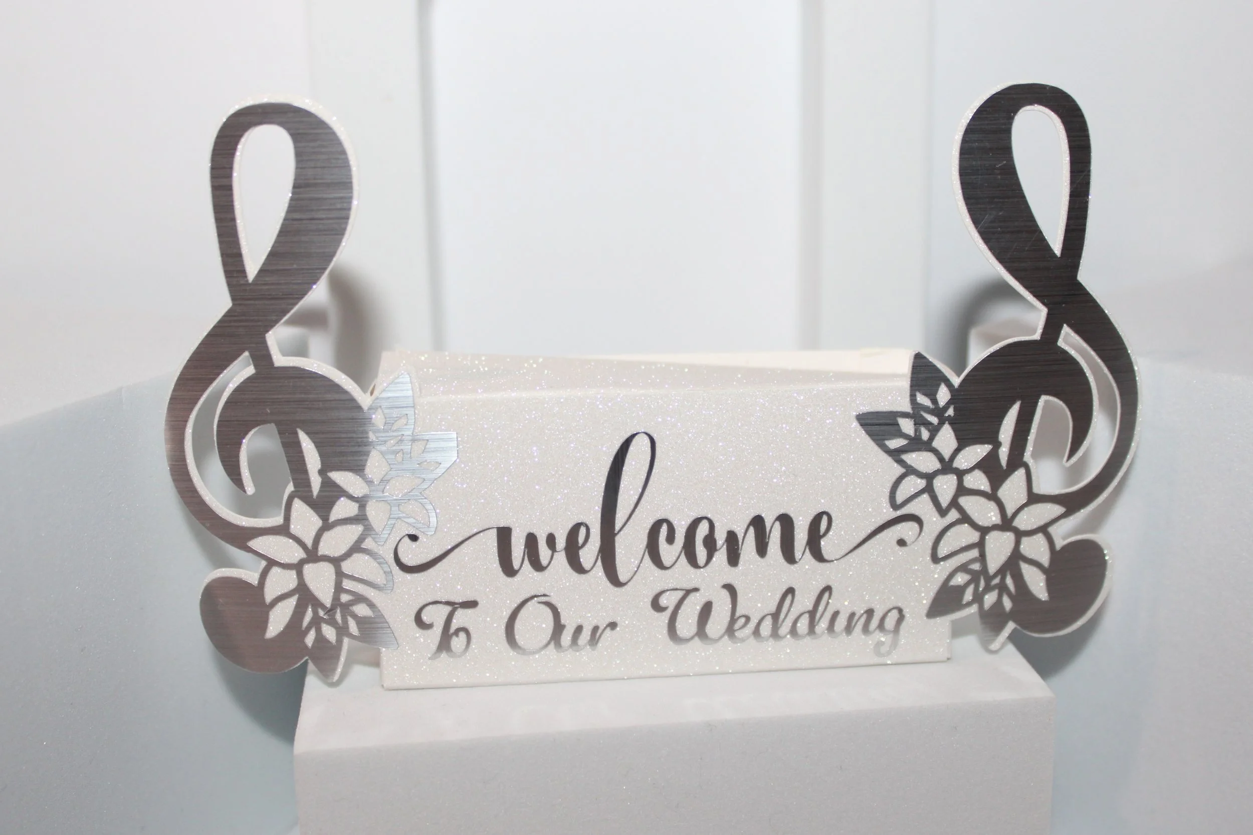 Musical notes favour box!
crafted from exquisite white glitter card, 

this box truly is stunning. the musical notes extend off the sides of the box & are finished in a gorgeous silver metallic vinyl. #0077

