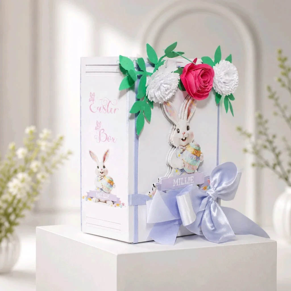 Easter Gift Box For Her! (Lilac)
Easter gift box shaped like a book, handcrafted with care and charming details. The cover features an AI-generated bunny illustration, precision-cut and layered for a dimensional look.  
Delicate paper flowers cluster