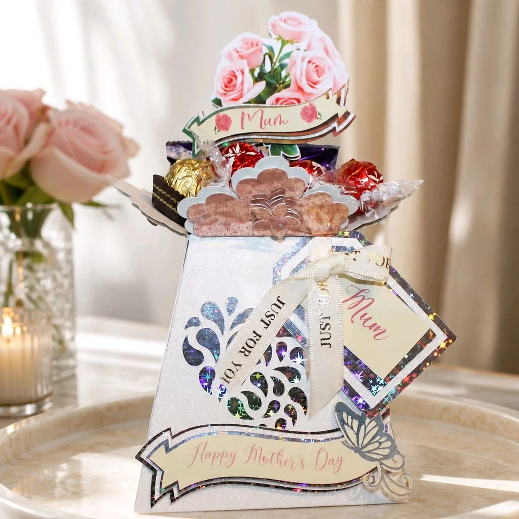 Mother’s Day vase filled with your favourite sweet treats — a delicate, handcrafted keepsake designed to delight and be treasured.  A coordinating gift tag is attached, ready for a personalised message to make the gift even more meaningful. 
Four-sid