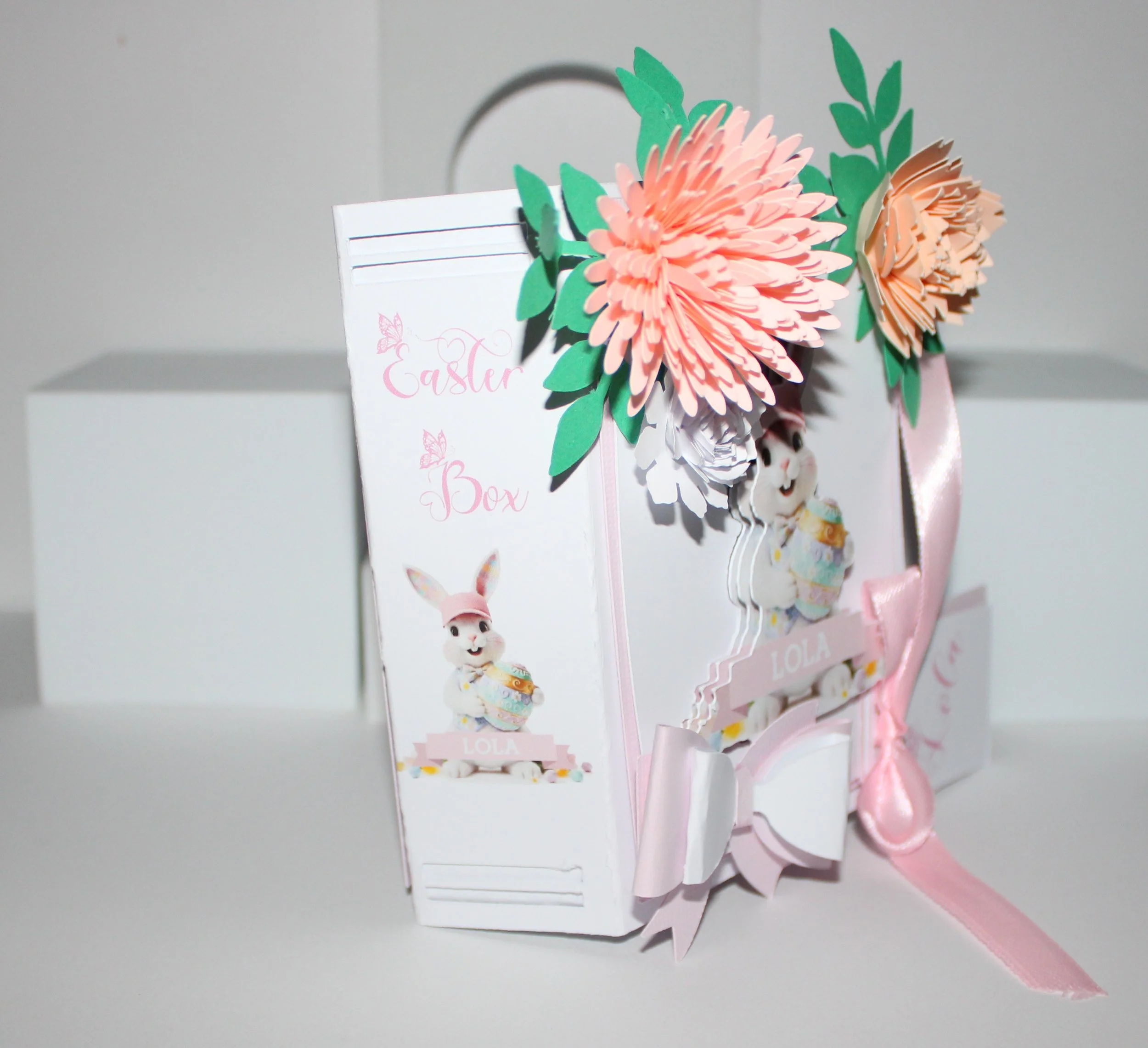 Easter Gift Box For Her! 
Easter gift box shaped like a book, handcrafted with care and charming details. The cover features an AI-generated bunny illustration, precision-cut and layered for a dimensional look. Delicate paper flowers cluster in the t