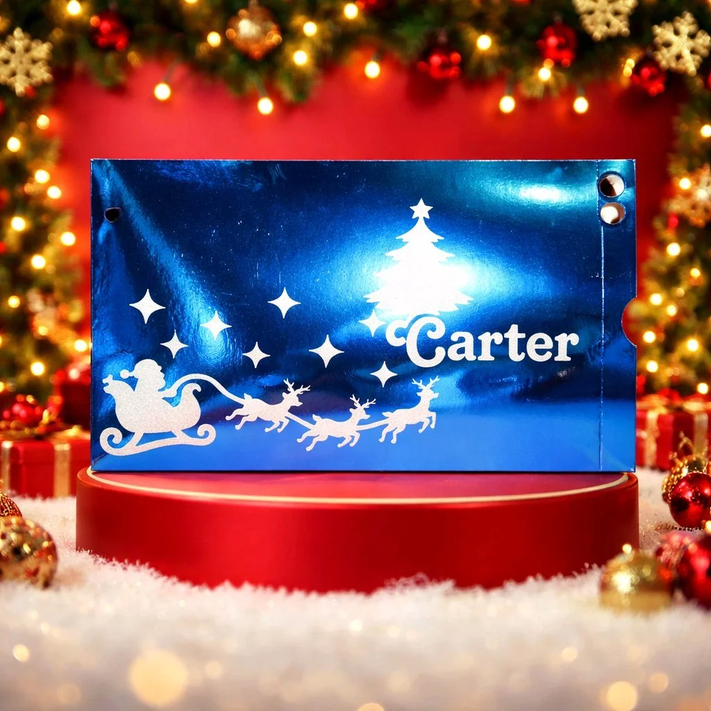 Personalised Santa Envelope Blue! These envelopes are cut in blue holographic card. The front has a silver vinyl Santa motif with personalised child's name. They are designed to fit those very important letters from Santa. Perforated end that simply 
