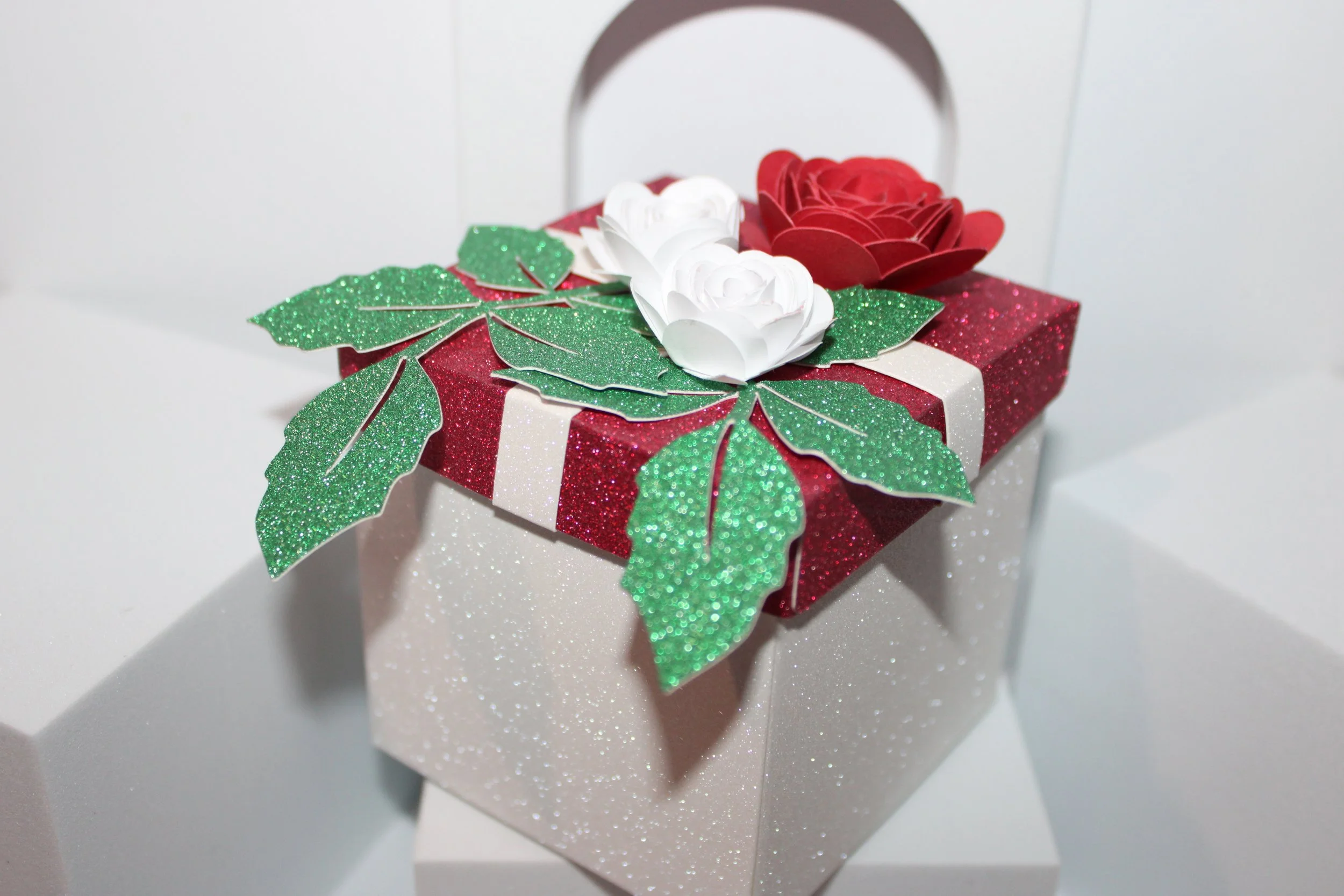 Ribbon box with roses favour box!
A stunning favour box adorned with gorgeous roses and card ribbon on the lid.
There is ample room for those sweet treats.
Crafted in beautiful red & white glitter cards.  #00123 